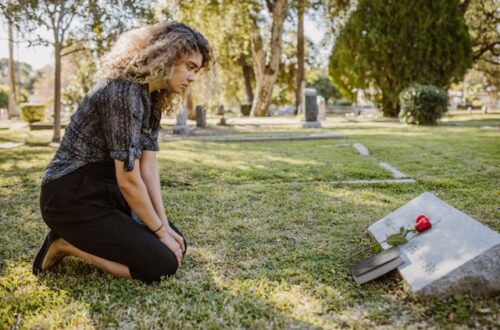 Women visit deceased family member at cemetery