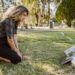 Women visit deceased family member at cemetery