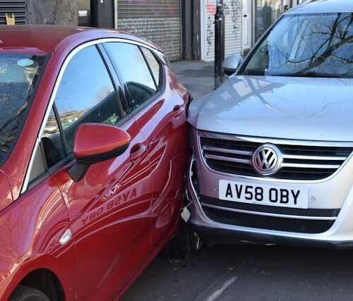 two cars parked next to each other in a parking lot